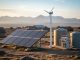 Off-grid solar array, micro wind turbine, and rainwater tanks with filtration unit on a remote plateau at golden hour, with softly blurred village huts and distant mountains in the background