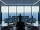 “Clean energy control room with glowing AI server equipment in front of a large window overlooking wind turbines and solar panels.”